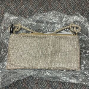 Express shimmering gold tone evening bag